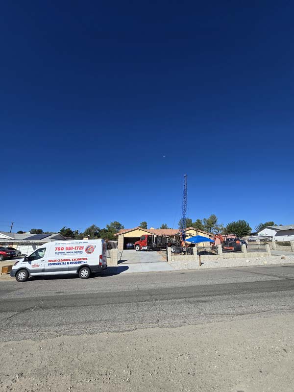 Inland Pro Plumbing service van and drilling equipment at Victorville septic project