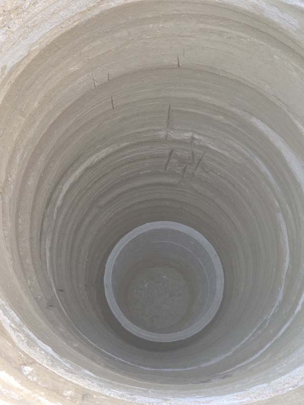 View down into the installed concrete liner rings of the Victorville septic seepage pit