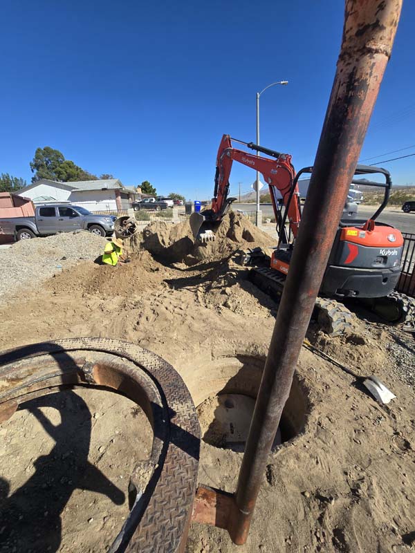 Excavation and drilling equipment at a Victorville septic seepage pit project