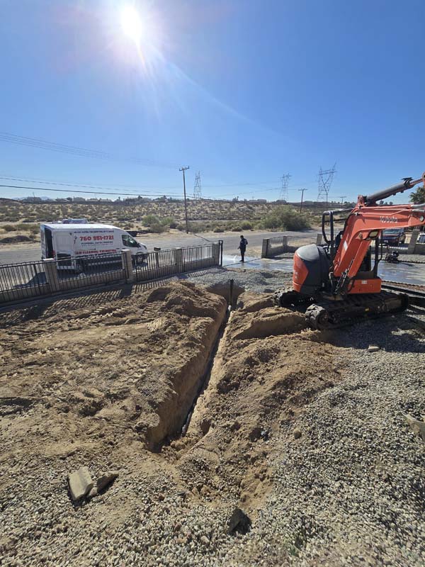 Excavated trench and Kubota excavator at Inland Pro Plumbing Victorville septic project
